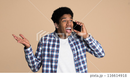Unexpected call. Surprised guy talking on phone over white background 116614918