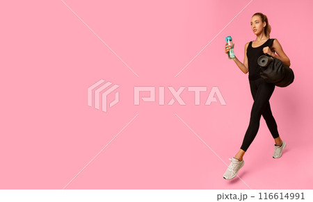 Girl Going To Gym Carrying Bag With Rolling Mat Over Yellow Studio Background. Fitness Lifestyle Concept. Full Length, Free Space Girl Going To Gym Carrying Bag With Rolling Mat Over Yellow Studio Background. Fitness Lifestyle Concept. Full Length, Free Space 116614991