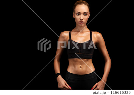 Determined Fitness Girl Looking At Camera Posing Over Black Studio Background. Copy Space 116616329