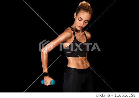 Determined Young Woman Working Out With Dumbbells On Black Studio Background. Strength Exercises. Copy Space 116616359