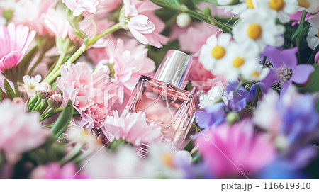Perfume bottle with beautiful flowers. Floral background. Beauty concept. Flat lay, top view. 116619310