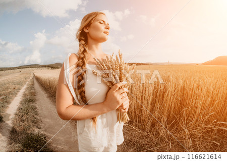 Woman wheat field. Agronomist, Woman farmer check golden ripe barley spikes in cultivated field. Closeup of female hand on plantation in agricultural crop management concept. Slow motion 116621614