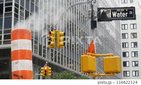 Steam vapor vented, New York City street steam system, orange vapour tube stack. Hot smoke from pipe Steam vapor vented, New York City street steam system, orange vapour tube stack. Hot smoke from pipe 116622124