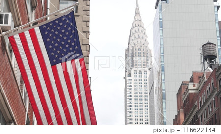 New York, american flag waving. Chrysler building. Manhattan midtown city street banner, patriotism. New York, american flag waving. Chrysler building. Manhattan midtown city street banner, patriotism. 116622134
