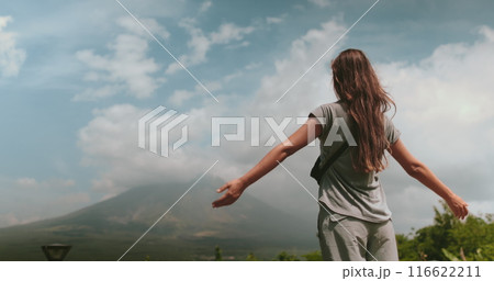 Woman enjoy Legazpi Mountains Volcano, Philippines. Asia wild nature tropical landscape. Tourist female rise hands , relax, outdoor lifestyle travel on summer holiday vacation. Back view 116622211
