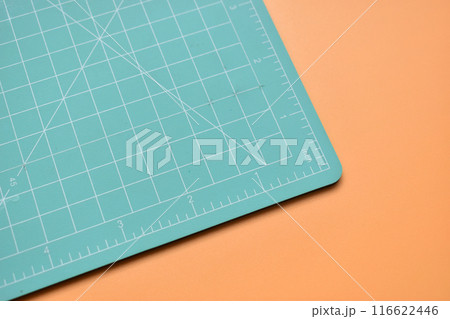 green cutting mat on orange background, object tool for design green cutting mat on orange background, object tool for design 116622446