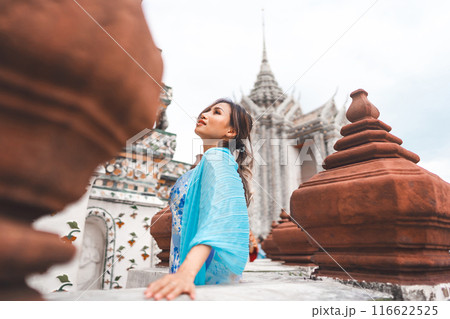 Asian woman blue dress cloth standing at Wat Arun temple travel in Bangkok Thailand Southeast Asia Asian woman blue dress cloth standing at Wat Arun temple travel in Bangkok Thailand Southeast Asia 116622525