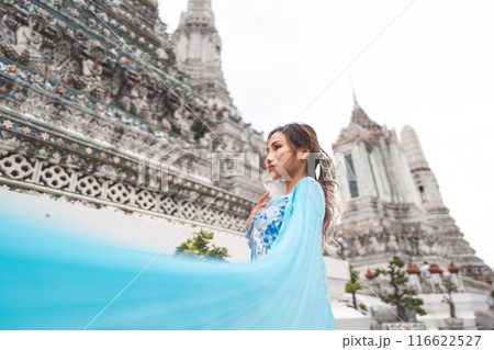 Asian woman blue dress cloth standing at Wat Arun temple travel in Bangkok Thailand Southeast Asia 116622527