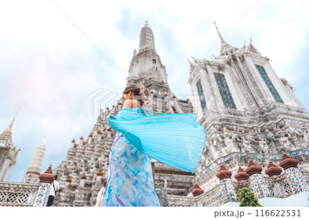 Rear view woman dress cloth standing at Wat Arun temple travel in Bangkok Thailand Southeast Asia Rear view woman dress cloth standing at Wat Arun temple travel in Bangkok Thailand Southeast Asia 116622531
