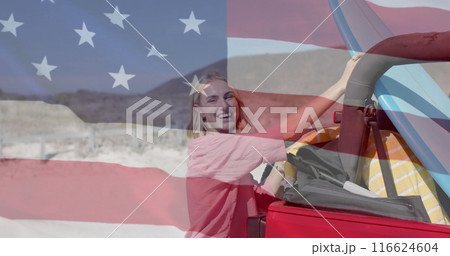 Image of flag of usa over caucasian woman by beach Image of flag of usa over caucasian woman by beach 116624604
