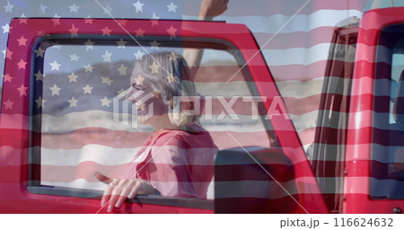 Image of flag of usa over happy caucasian woman by car on beach 116624632