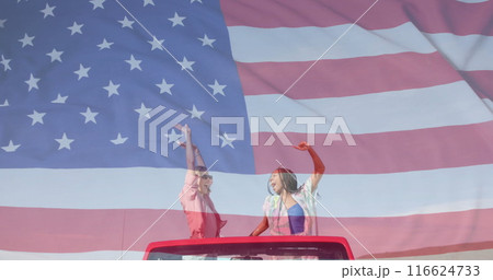 Image of flag of usa over happy diverse women in car by beach in summer Image of flag of usa over happy diverse women in car by beach in summer 116624733