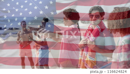 Image of flag of usa over happy diverse friends on beach in summer 116624824