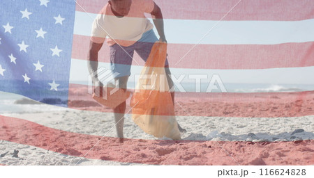 Image of flag of usa over african american man recycling on beach in summer Image of flag of usa over african american man recycling on beach in summer 116624828