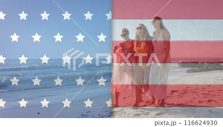 Image of flag of usa over happy diverse friends on beach in summer 116624930