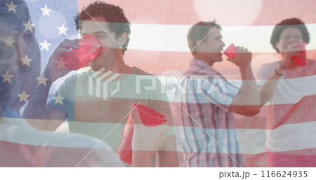 Image of flag of usa over happy diverse friends at beach party in summer Image of flag of usa over happy diverse friends at beach party in summer 116624935