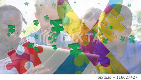 Images of colorful puzzle pieces and ribbon over diverse group of children Images of colorful puzzle pieces and ribbon over diverse group of children 116627427