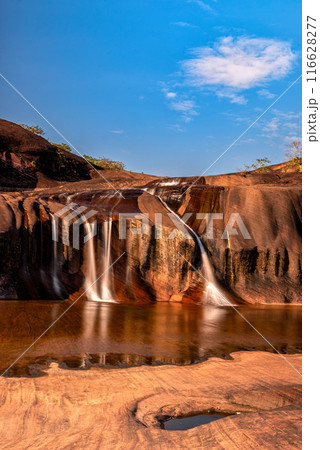 Tham Phra Waterfall Waterfall located in Bueng Kan Province, Thailand. There will be little water in the summer Tham Phra Waterfall Waterfall located in Bueng Kan Province, Thailand. There will be little water in the summer 116628277