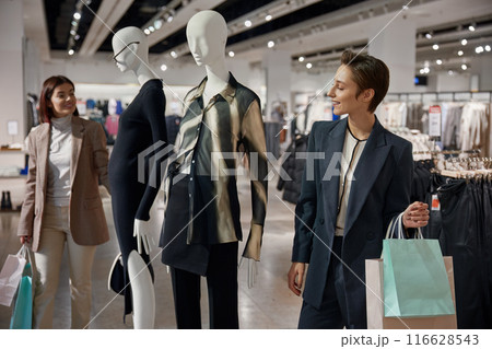 Two young elegant women friends engaged in shopping tourism 116628543