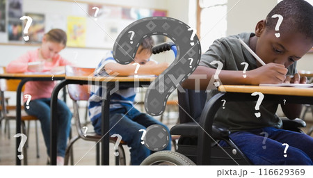 Image of question marks over diverse schoolchildren sitting in classroom 116629369