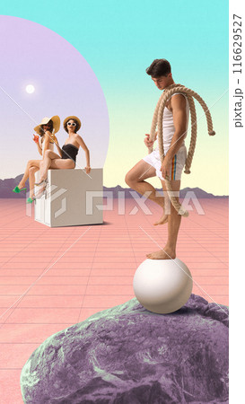 Handsome man in white outfit balancing on large ball with ropes, while two women in swimsuits and sun hats sit on cube and watching, set against pastel surreal landscape. Contemporary art collage. 116629527