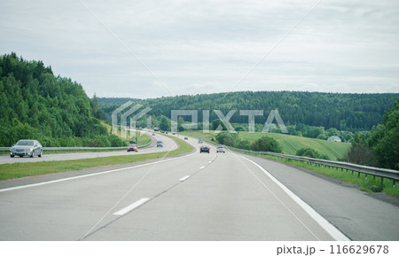 cars on the highway, asphalt road among the forest with cars, travel 116629678