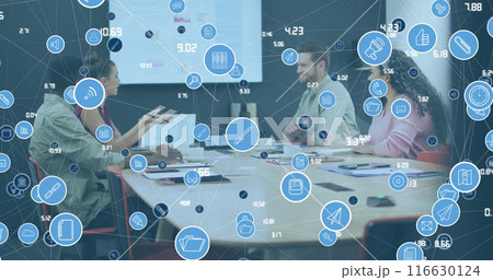 Image of network of icons over diverse colleagues discussing together at office 116630124