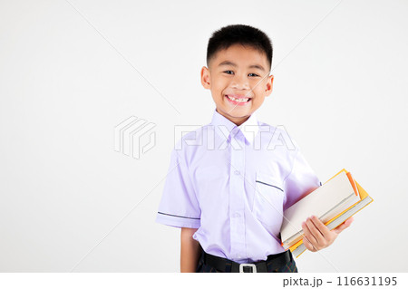 Portrait smile Asian little boy primary posing hand holding book studio isolated white background, happy cute man kid wear school uniform plaid, back to school concept 116631195