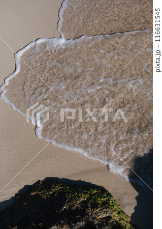 Spanish Beach with its pink and red sand and transparent water. Soft beautiful sea wave on sandy beach. Background. 116631545