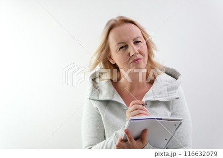 Woman writing with pen. girl's hand makes corrections to the project documentation with a pen. business 116632079