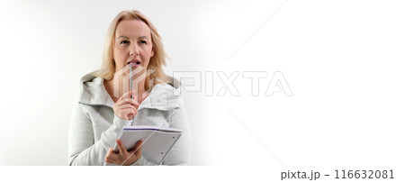 Close up tilt down shot of young Caucasian woman filling out application form before interview in embassy Close up tilt down shot of young Caucasian woman filling out application form before interview in embassy 116632081