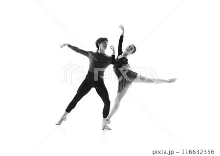 Ballet duo in sync during intense training session against white studio background. Monochrome filter. Elegance. 116632356
