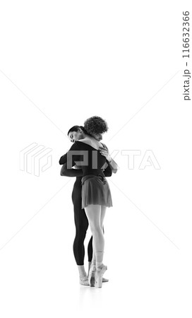 Sensitive moment on training session when ballerina hugs her partner against white studio background. Black and white filter. Sensitive moment on training session when ballerina hugs her partner against white studio background. Black and white filter. 116632366