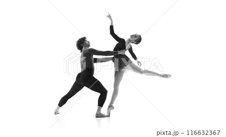 Fluid and synchronized. Ballet partners during practice against white studio background. Black and white filter. 116632367