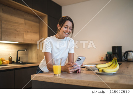 Cute smiling young woman at home having a call on the phone Cute smiling young woman at home having a call on the phone 116632659