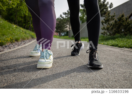 Unrecognizable women running during sunny morning Unrecognizable women running during sunny morning 116633196