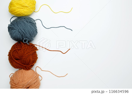 Color yarn for knitting, white background. Top view. Copy space, flat lay Color yarn for knitting, white background. Top view. Copy space, flat lay 116634596