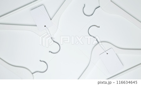 Creative flat lay hangers with white paper label. Clothing tag, label blank mockup template. Sale discount store promo shopping concept. Top view. Copy space 116634645