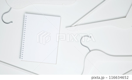 Creative flat lay hangers with white paper label. Clothing tag, label blank mockup template. Sale discount store promo shopping concept. Top view. Copy space 116634652