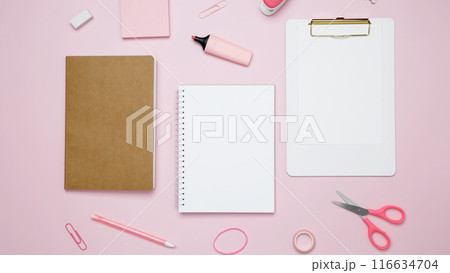 Creative flat lay mockup design of workspace. Top view composition with white notebook, to do list and stationery on pink background Creative flat lay mockup design of workspace. Top view composition with white notebook, to do list and stationery on pink background 116634704