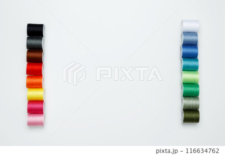 Multicolored sewing threads on white background. Top view, copy space 116634762