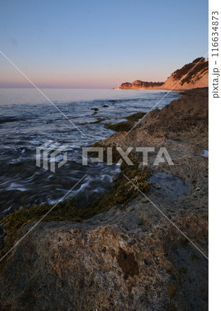 seascape rocky beach at sunset 116634873