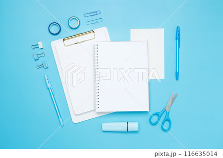 Creative flat lay mockup design of workspace. Top view composition with white notebook, to do list and stationery on blue background Creative flat lay mockup design of workspace. Top view composition with white notebook, to do list and stationery on blue background 116635014