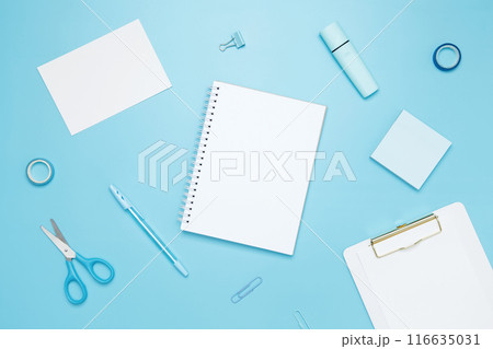 Creative flat lay mockup design of workspace. Top view composition with white notebook, to do list and stationery on blue background 116635031