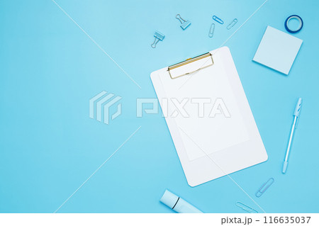 Creative flat lay mockup design of workspace. Top view composition with white notebook, to do list and stationery on blue background Creative flat lay mockup design of workspace. Top view composition with white notebook, to do list and stationery on blue background 116635037