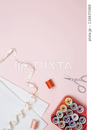 Composition with various threads and sewing accessories on pink background. Top view, copy space 116635060