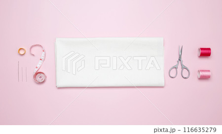 Composition with various threads and sewing accessories on pink background. Top view, copy space 116635279