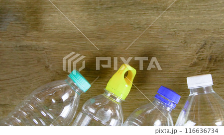 Waste plastic bottles on wooden background waiting for recycling concept of saving our environment sustainable natural resources. 116636734