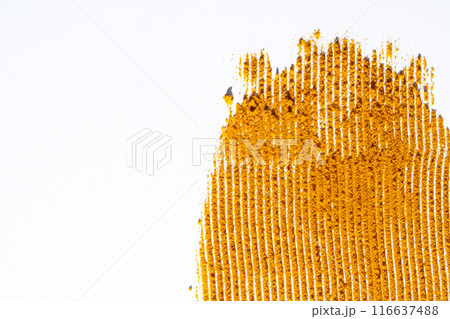 A smear of turmeric on a white background, top view 116637488