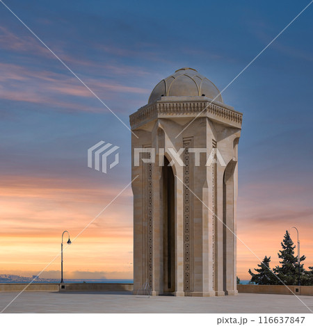 Eternal Flame Monument in Baku, Azerbaijan stands tall against a backdrop of a colorful sunset sky 116637847